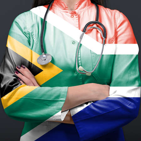 Doctor representing healthcare system with National flag of South Africaの写真素材