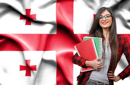 Woman holding blank board against national flag of Belgiumの写真素材