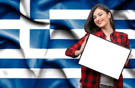 Young female Tourist holding Earth Globe against flag of Equatorial Guineaの写真素材