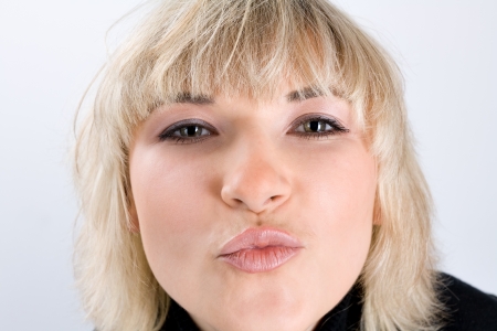 Beautiful blond model trying to kiss a cameraの写真素材