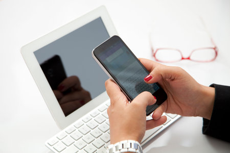 Businesswoman  entrepreneur using smartphone and laptop at  office