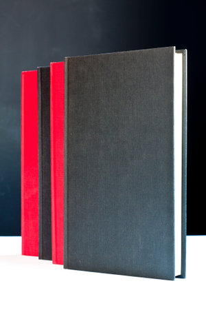 Black and red books with black backgroundの写真素材
