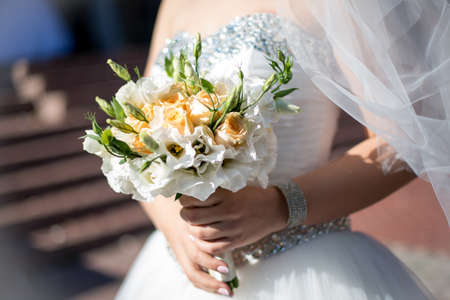 Beautiful wedding bouquet in hands of the brideの写真素材