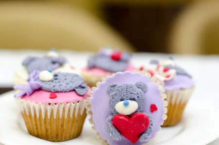 Cupcakes with teddy bear and hearts on white rustic background. Valentine's Day cupcake.の写真素材