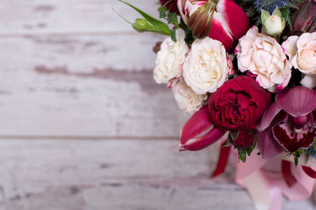 beautiful floral arrangement, on shabby white wooden table with space for textの写真素材