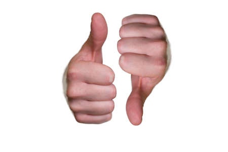 Closeup of male hands with one thumb up and one thumb down isolated on white backgroundの写真素材