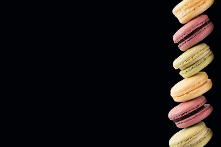 Sweet Tasty Macaroons Isolated on black Background with space for textの写真素材