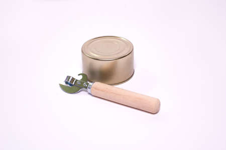 vintage bottle opener with wooden handle and tin can on white background with space for textの写真素材