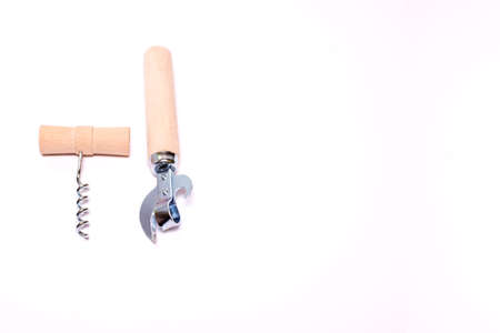 corkscrew with wooden handle and vintage can opener with wood handle isolated on white background with space for textの写真素材