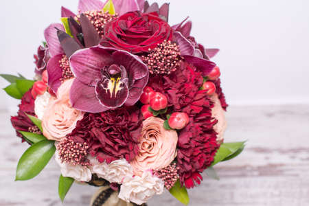 beautiful floral arrangement, on shabby white wooden table with space for textの写真素材