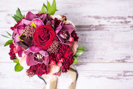 beautiful floral arrangement, on shabby white wooden table with space for textの写真素材