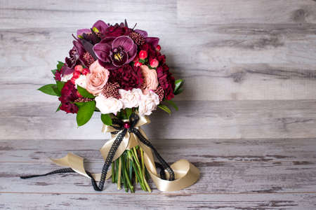 wedding bouquet, the beautiful floral arrangement, on the shabby wooden table with space for textの写真素材