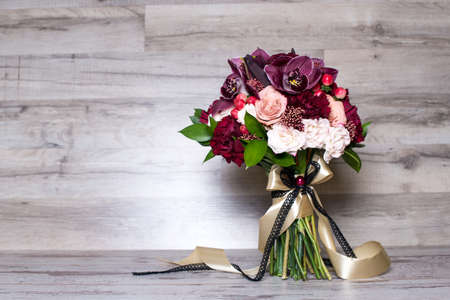 wedding bouquet, the beautiful floral arrangement, on the shabby wooden table with space for textの写真素材
