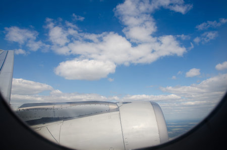 Clouds and sky as seen through window of an aircraft.の写真素材