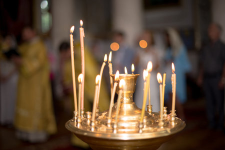ambiance of church, candles and bokeh yellow lights.