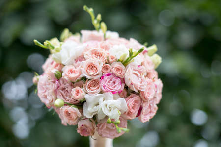 pink and white wedding bouquet on a green backgroundの写真素材