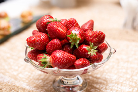 Strawberries in vase. Large strawberries are red and delicious. Berry for diet rich in vitamins.の写真素材