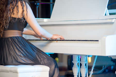 Close-up of a music performer's hand playing the piano.の写真素材