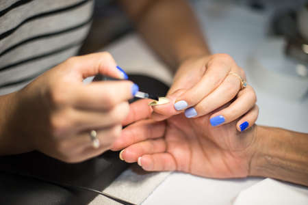 Manicure. Master make nail paint. hands closeupの写真素材