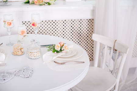 Dining table setting at Provence style, with candles, lavender, vintage crockery and cutlery, closeup.の写真素材