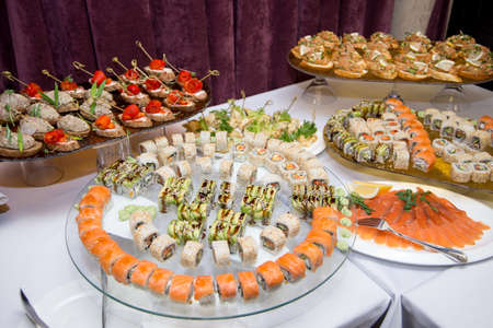 Japanese Cuisine -Buffet catering style Sushi Set in restaurant - salmon Maki Sushi and Nigiri Sushi. selective focus.の写真素材