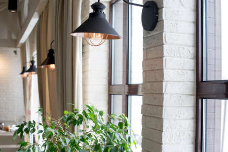 a lamp on the background of a window and a wall with curtains.の写真素材
