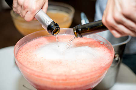 Beverage with ice cubes. Pouring champagne. mint and fruit are out of focusの写真素材