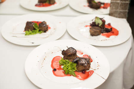 fried beef steaks with spices, on a white table.の写真素材