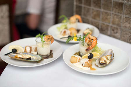 Seafood sets at local restaurant, fine dining, Fresh seafood platter with , mussels and on plate with tartar sauce.の写真素材