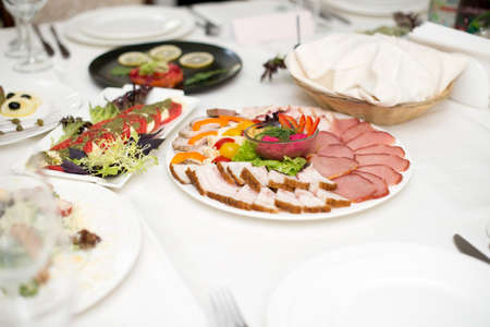 Meat assortment of beef, sausage and ham with greens.の写真素材