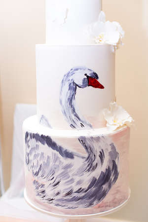 Cake with a picture Swan, with white flowers.の写真素材