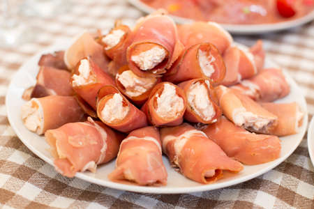 tasty meat rolls with ham and cheese and greens.の写真素材