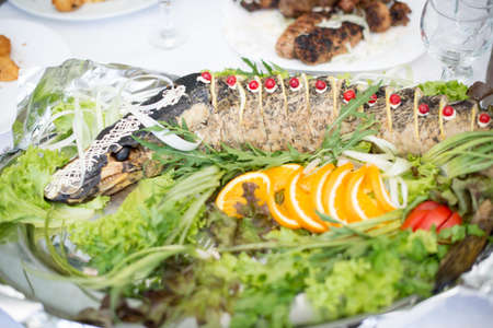 pike prepared fish and some salads behaind.の写真素材