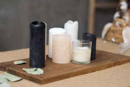 candles black white, on a wooden stand on a table with sackingの写真素材