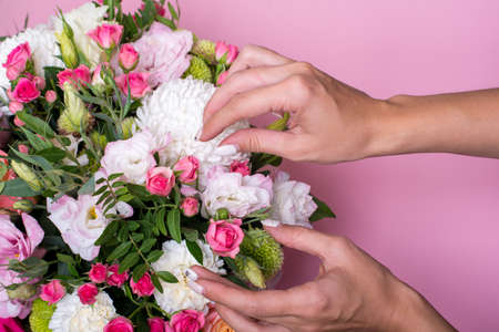 Female florist making beautiful bouquet at flower shopの写真素材