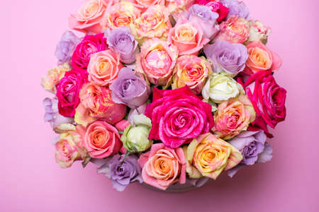 Beautiful bouquet of roses in a gift box. Bouquet of pink roses. Pink roses close-up. on pink background, with space for text.の写真素材