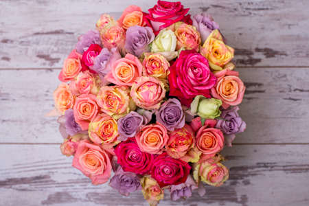 Beautiful bouquet of roses in a gift box. Bouquet of pink roses. Pink roses close-up. on wooden background, with space for textの写真素材