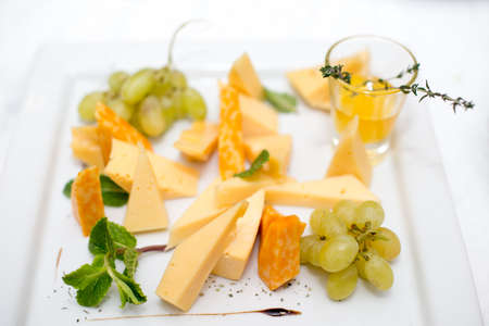 Tasty appetizer. Plate of Cheese on white plate at a restaurantの写真素材