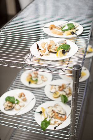 Scallops, creatively arranged food on a white restaurant plate.