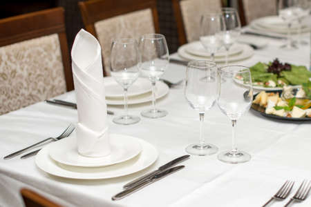 The white napkin nicely folded on the plates, serving a celebratory banquet.の写真素材