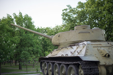 Tank close-up. Iron caterpillars and wheels of a military heavy tank. View of the front part of the...