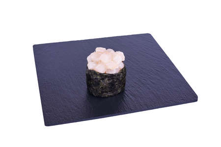 Traditional fresh japanese sushi on black stone Gunkan Izumidai on a white background. Gunkan ingredients: amaze kun, nori, riceの写真素材