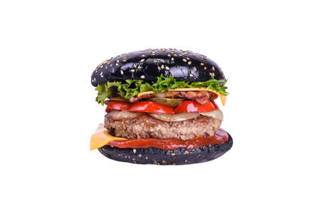 Black burger with pork and beef meat, bacon, cheddar, pickled cucumber, bulgarian pepper, grilled onion, salad mix, special sauce isolated on a whiteの写真素材