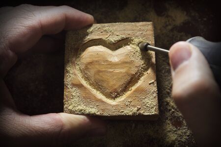 carving wood in heart shapeの写真素材