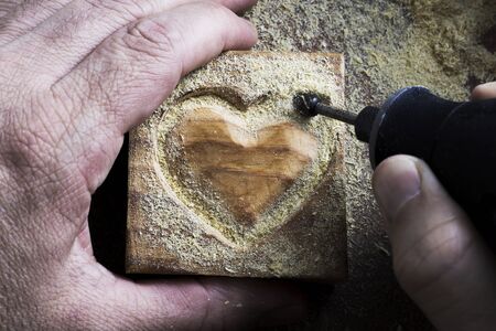 carving wood in heart shapeの写真素材