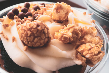 delicious dessert with popcorn in caramel syrup on a warm cream tinted cream closeup.の写真素材