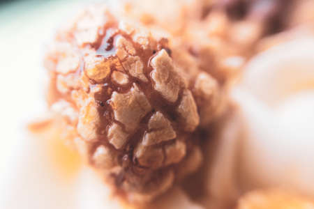tasty popcorn in caramel syrup, warm toned close-up on blurred background . concept in a cafe or restaurant.の写真素材