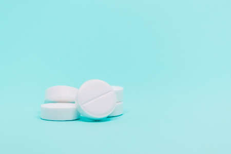 white round pills on a blue background close-up layoutの写真素材