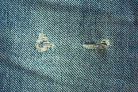 fabric ripped hole classic denim jeans close up textureの写真素材