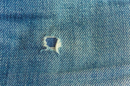 fabric ripped hole classic denim jeans close up textureの写真素材